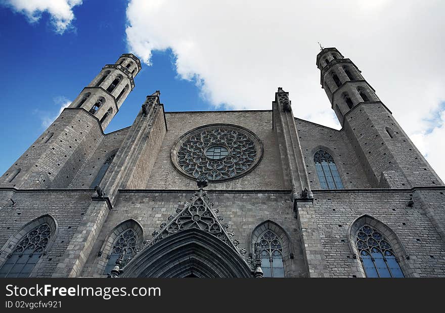 Outside view looking up towards a cloudy blue sky, of the Santa Maria del Mar church in Barcelona. Outside view looking up towards a cloudy blue sky, of the Santa Maria del Mar church in Barcelona.