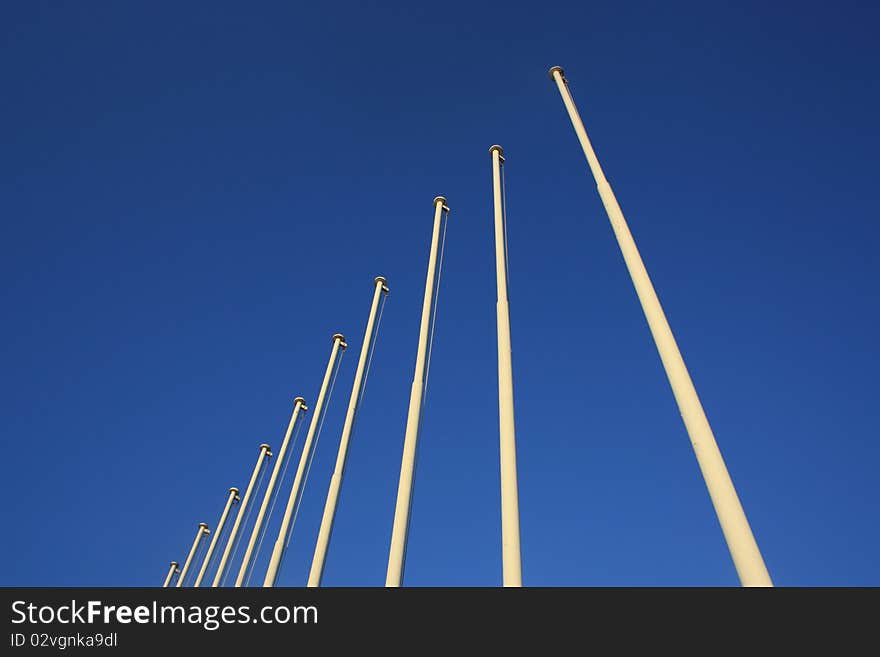 Olympic Flag Poles against a bright blue sky