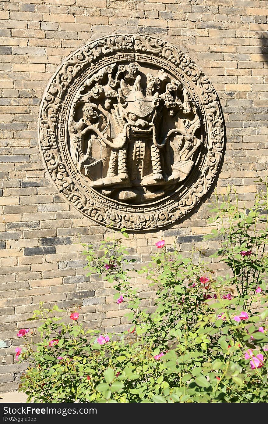 The relievo of dragon-head on the wall in Chinese temple. The relievo of dragon-head on the wall in Chinese temple