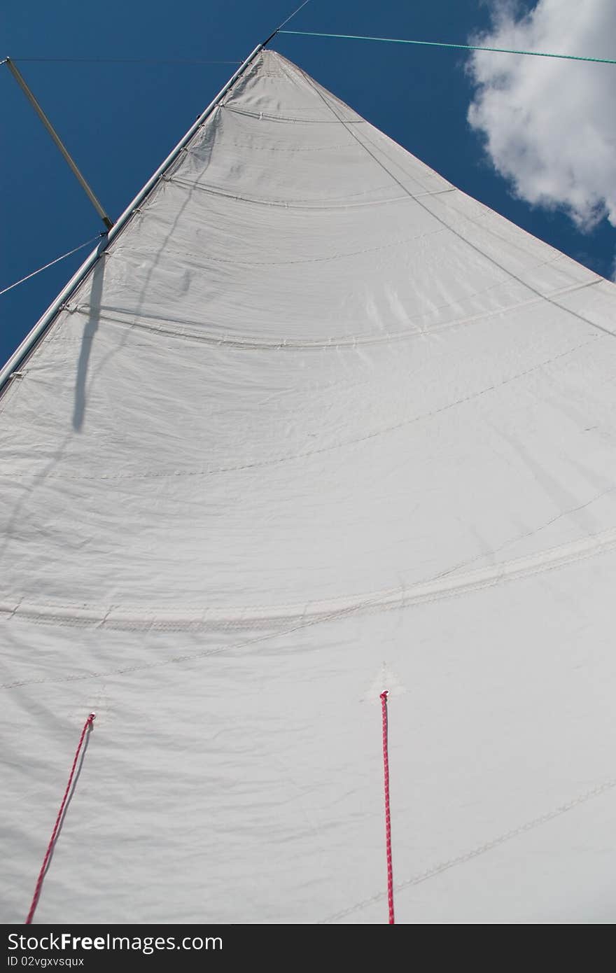 White sail on the blue sky background