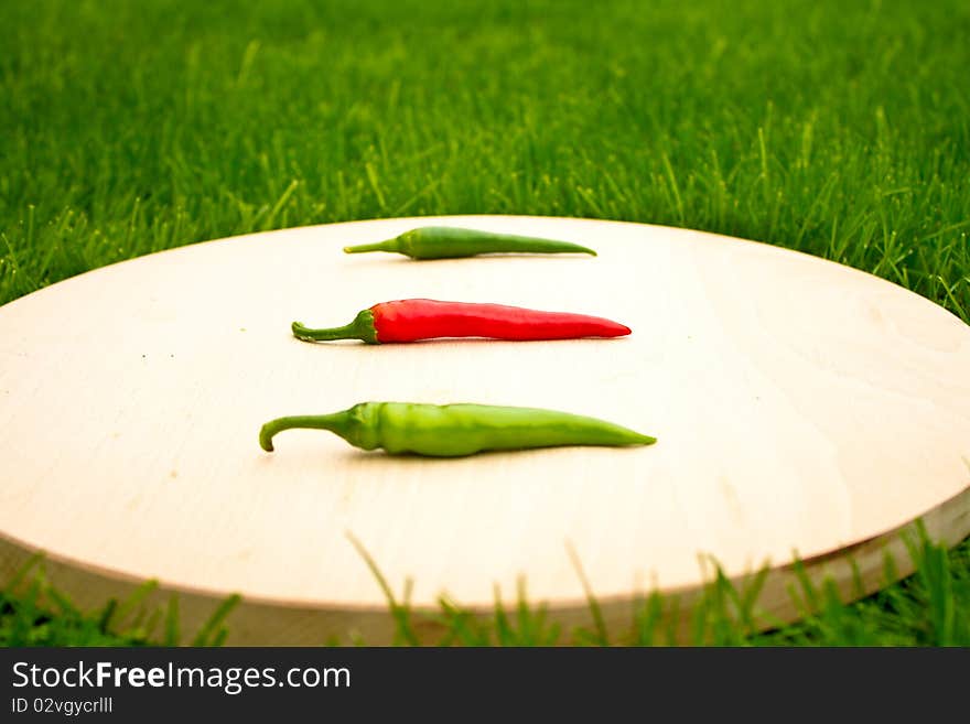 Three chilli hot red and green peppers (focus on red one). Three chilli hot red and green peppers (focus on red one)