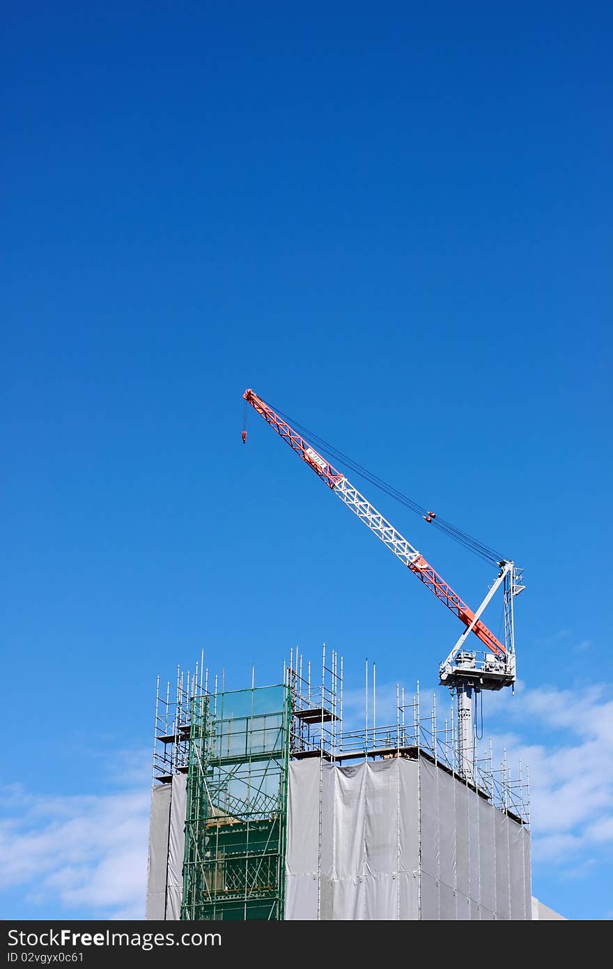 Construction crane on a sky background