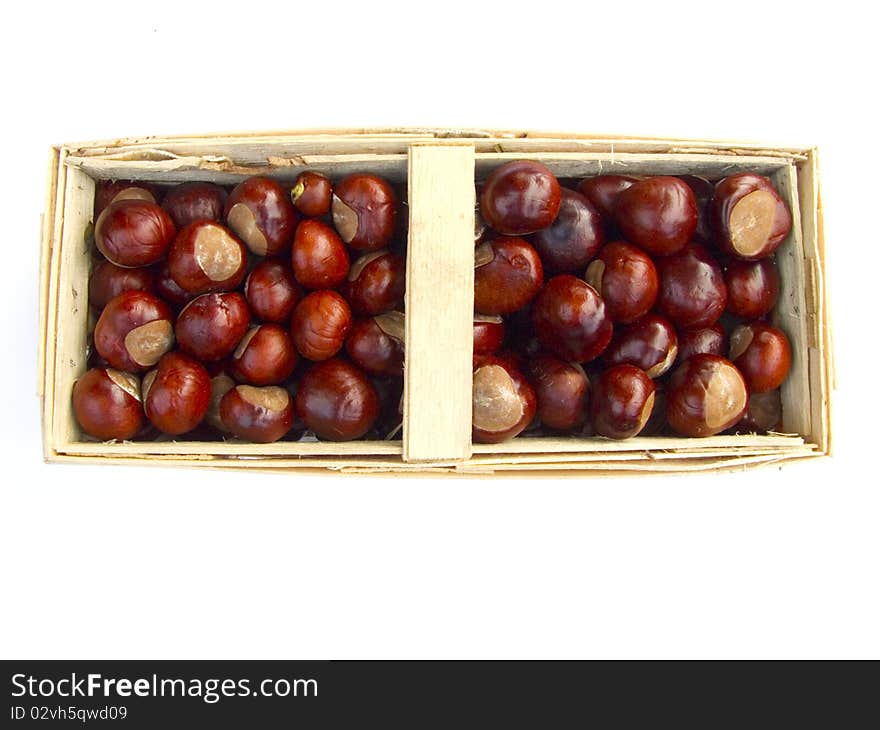 Chestnuts in a basket isolated on white background. Chestnuts in a basket isolated on white background