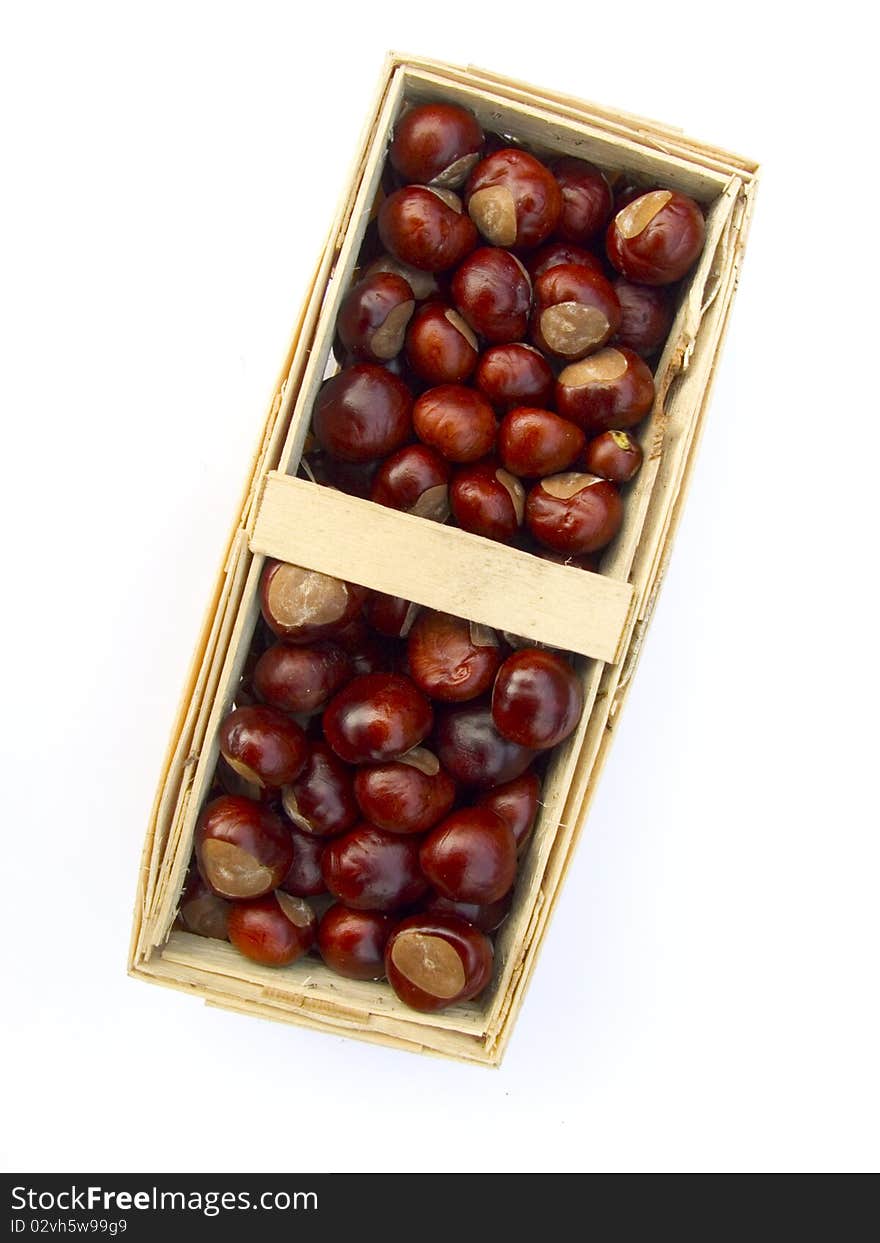 Chestnuts in a basket isolated on white background