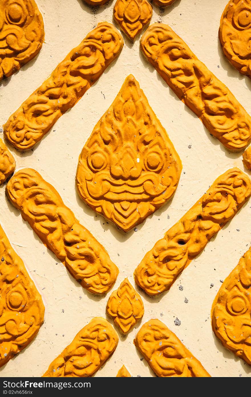 Thai Yellow-orange Stucco in a temple. Thai Yellow-orange Stucco in a temple