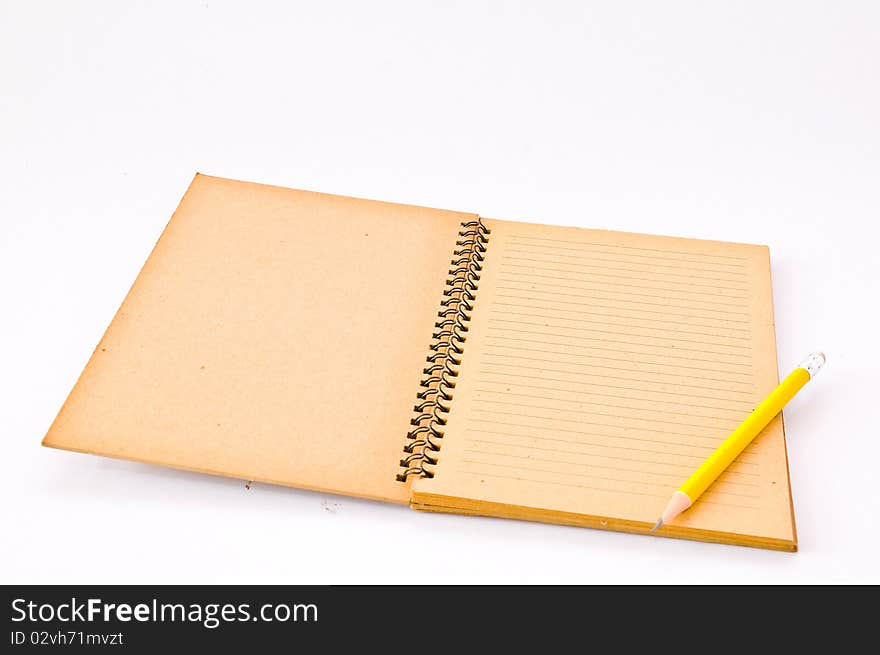 Brown Spiral Notebook with yellow pencil