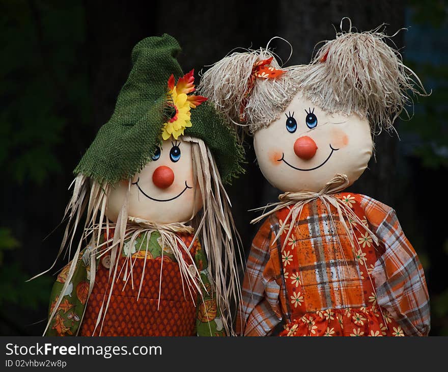 Two scarecrow dolls side by side