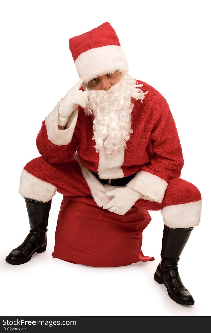 Santa claus is sitting on the sack and thinking