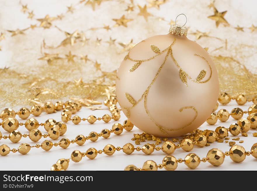 Golden christmas decoration with ball and pearl necklace