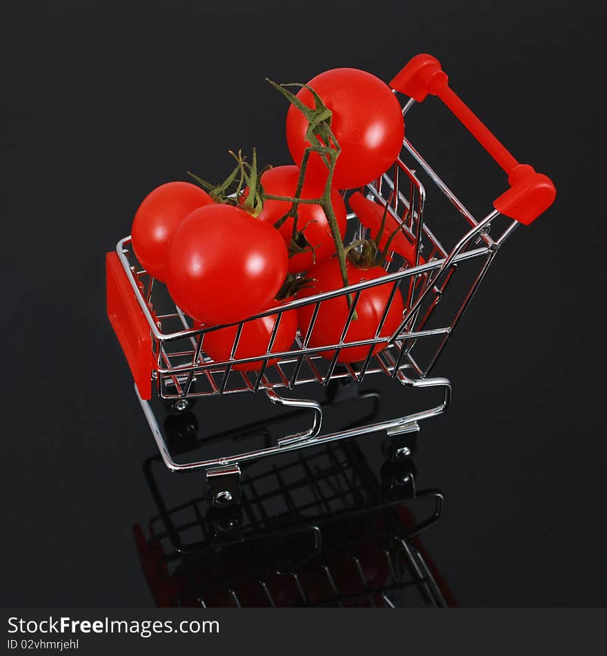 Organic tomatoes in shopping cart - square crop