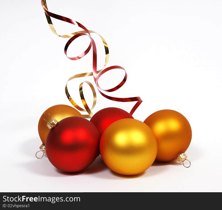 Yellow and red glass balls with ribbons on the white background. Yellow and red glass balls with ribbons on the white background