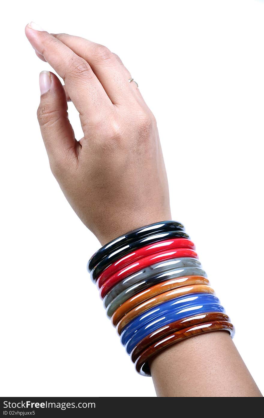 Female hand wearing glass bangles on white background. Female hand wearing glass bangles on white background.