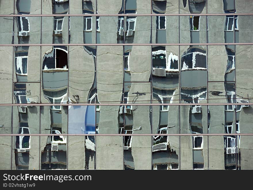 Mirorred wall of city scyscraper abstract background. Distorted reflection of next building. Mirorred wall of city scyscraper abstract background. Distorted reflection of next building