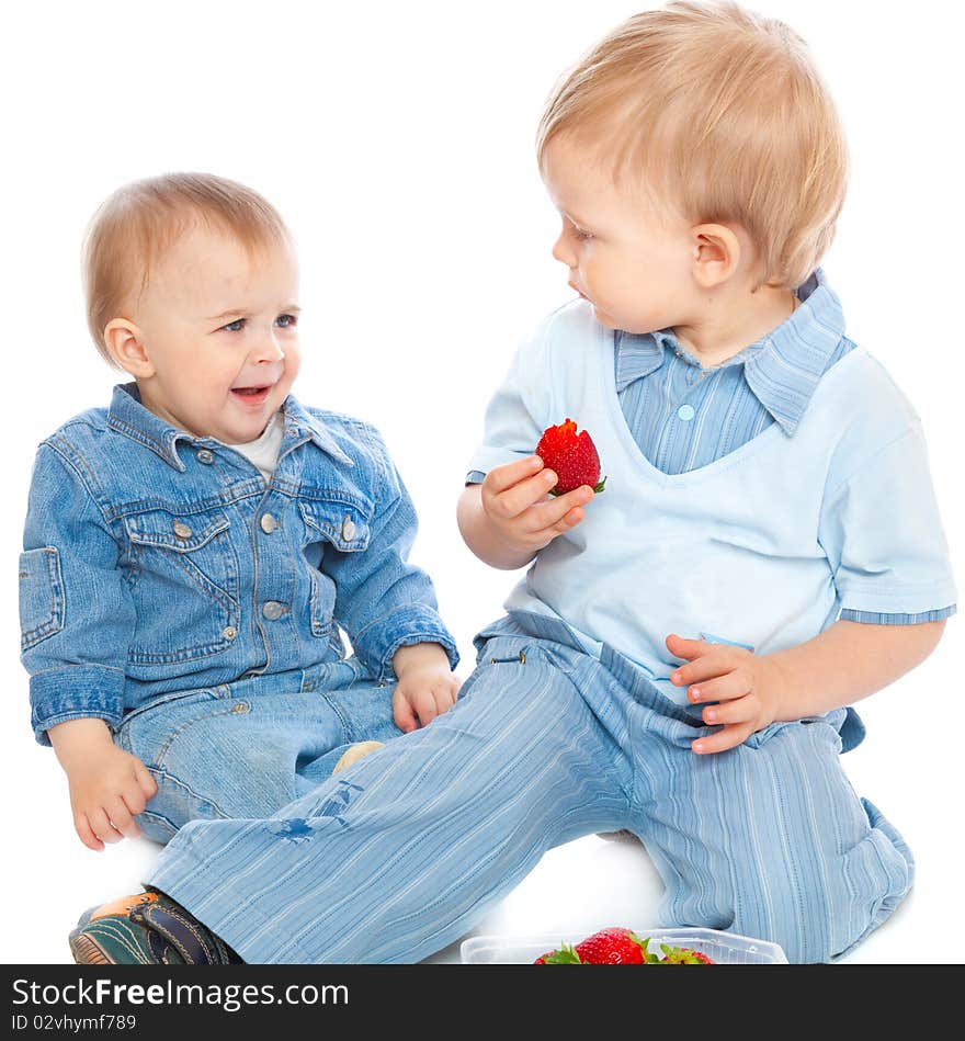 Two brothers with strawberry. Isolated on white background