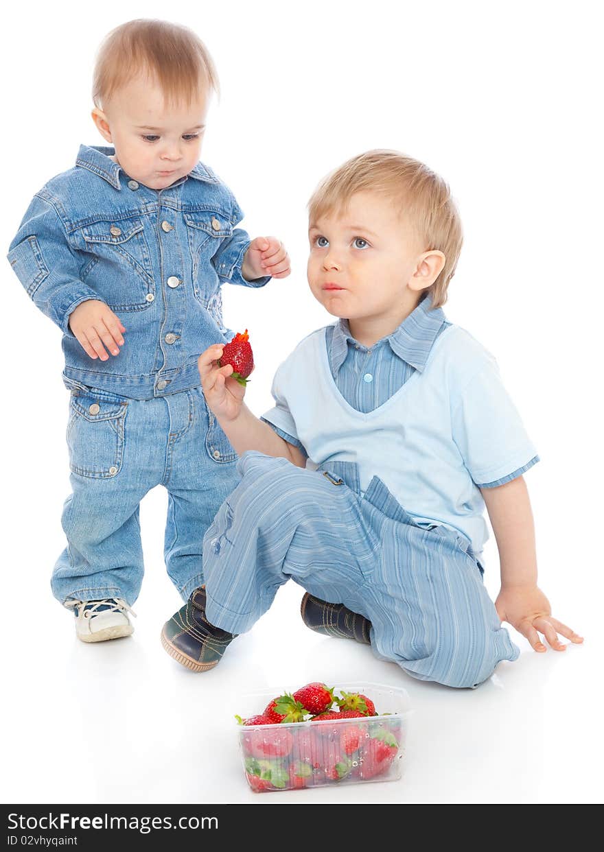 Two brothers with strawberry. Isolated on white background