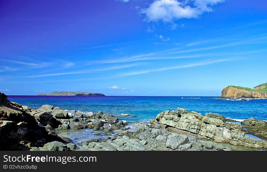 Rocks meet the Carribean Sea on a deserted tropical island. Rocks meet the Carribean Sea on a deserted tropical island.