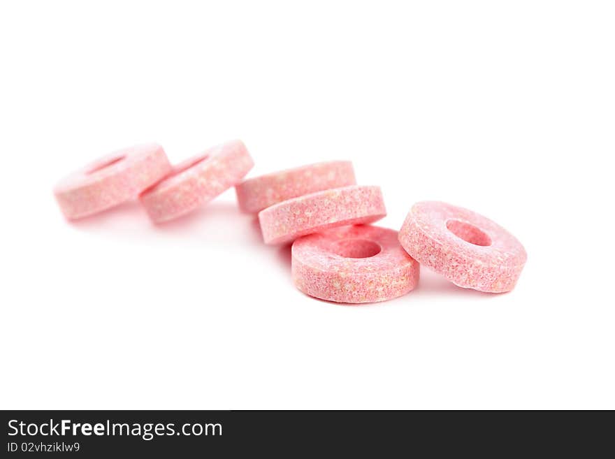 Pink vitamin candies isolated on white