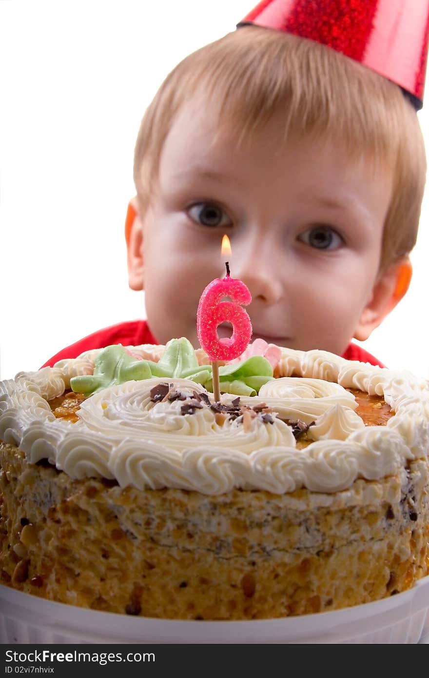 Happy boy with a cake on a white background