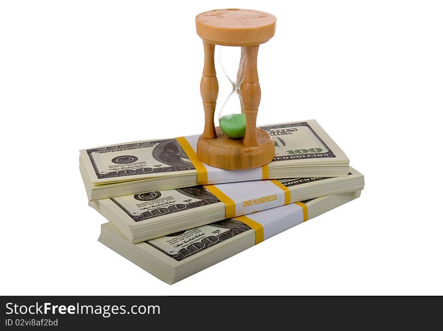 Hourglass on a packs of dollars  isolated on a white background