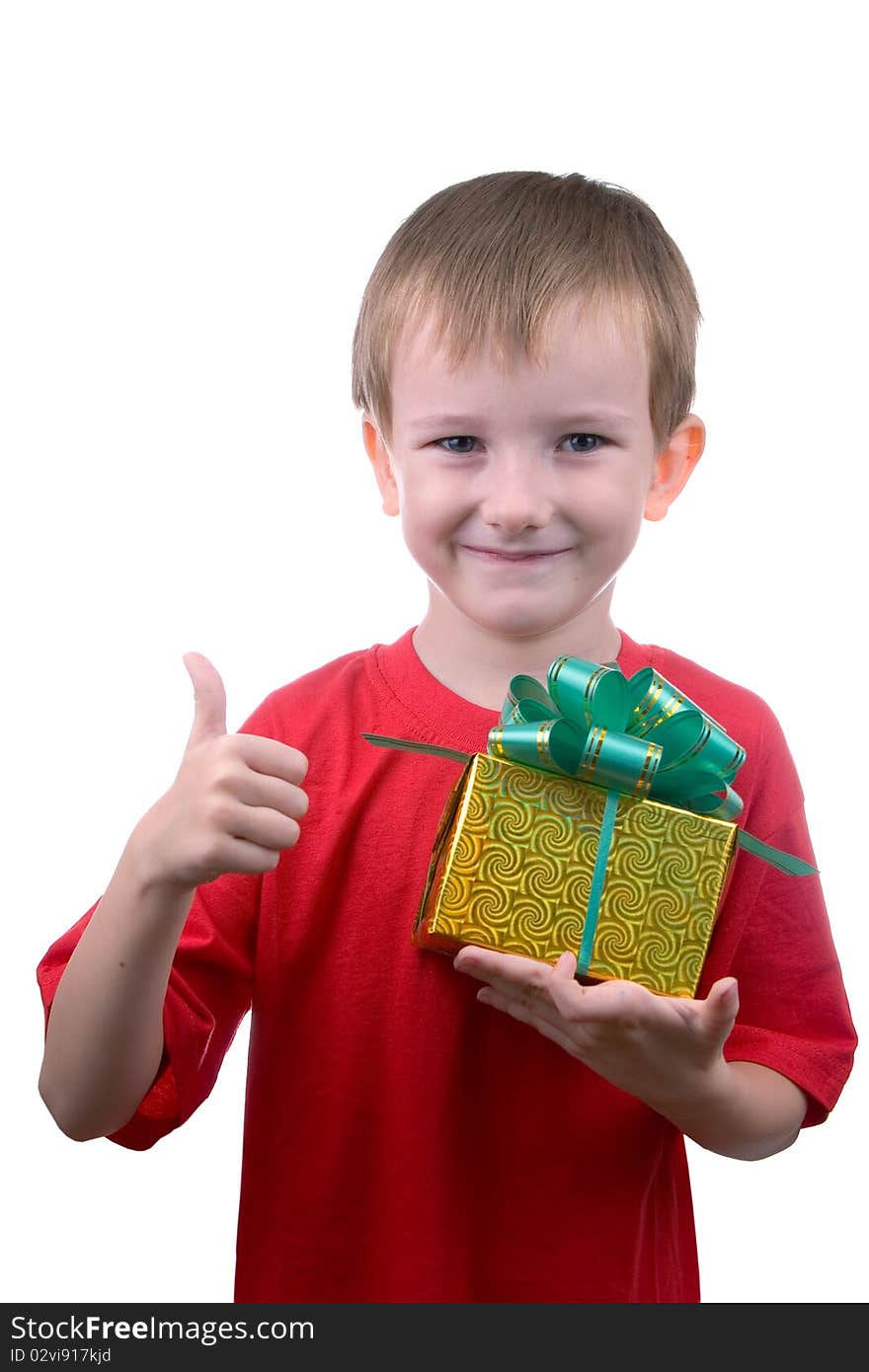 Happy boy with a gift shows the sign of OK, isolated on a white background. Happy boy with a gift shows the sign of OK, isolated on a white background