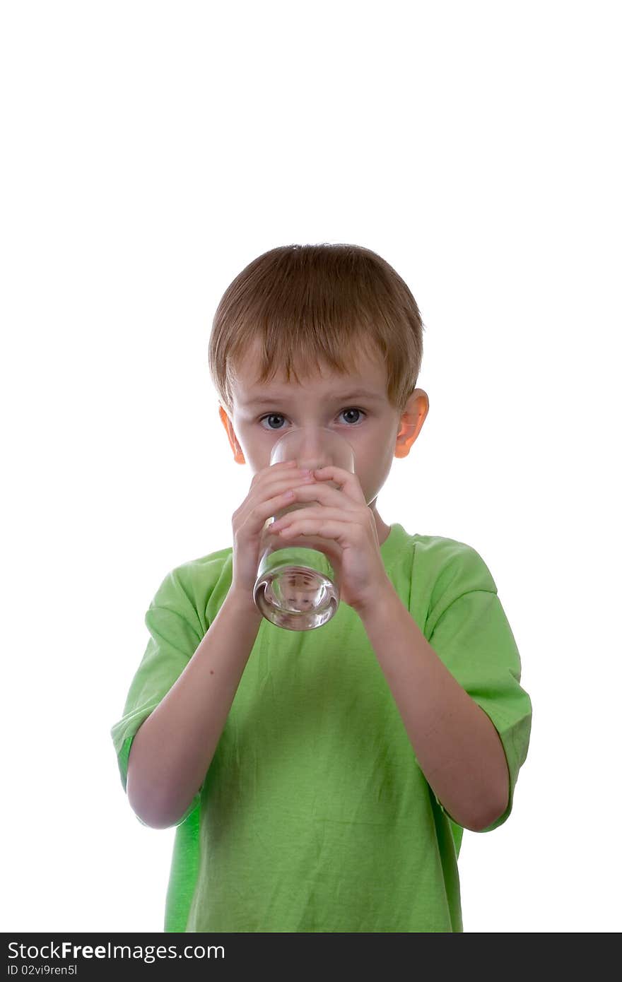 Boy drinks water from a glass on a white background