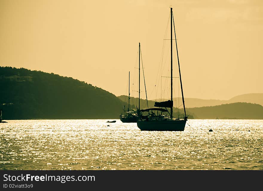 Two luxury sailboats anchor in Francis Bay, St. John US Virgin Islands at sunset. Two luxury sailboats anchor in Francis Bay, St. John US Virgin Islands at sunset.