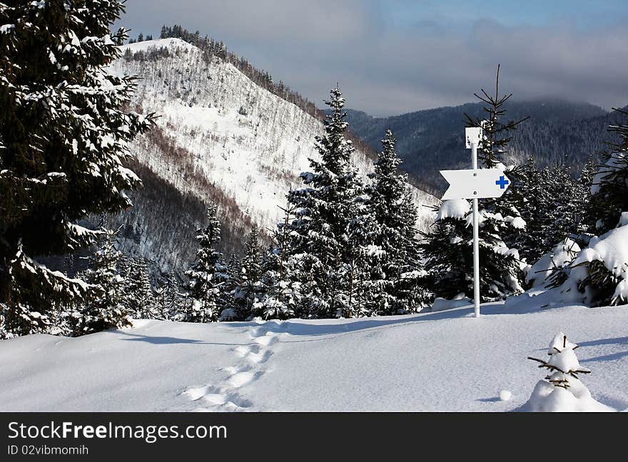 Directional sign in mountains; and thick snow. Directional sign in mountains; and thick snow