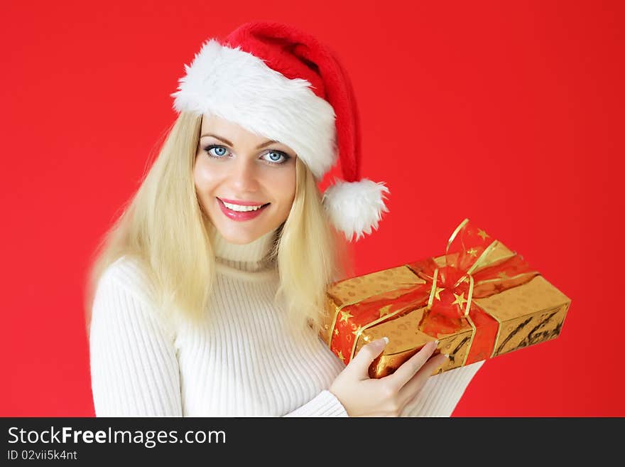 Santa girl holding gifts on a red background