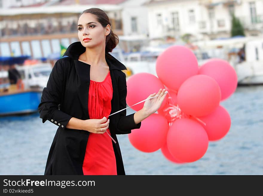 Young beautiful woman with red balloons