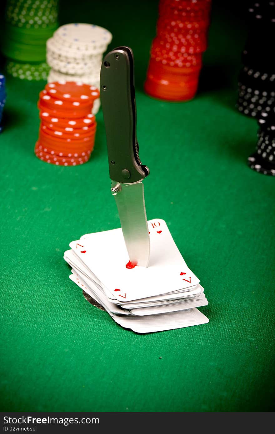 Casino gambling chips, cards and knife on green table. Casino gambling chips, cards and knife on green table