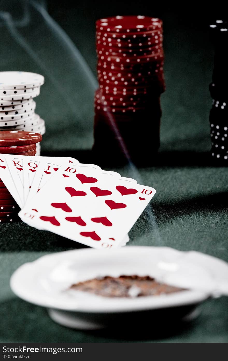 Casino gambling chips and playing cards on green table. Casino gambling chips and playing cards on green table