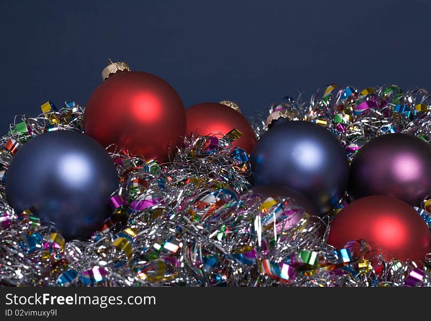 Holiday tree ornaments on tinsel garland