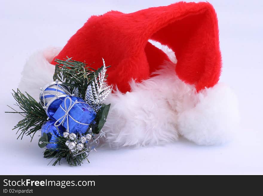 Santa hat and holiday decoration on white.