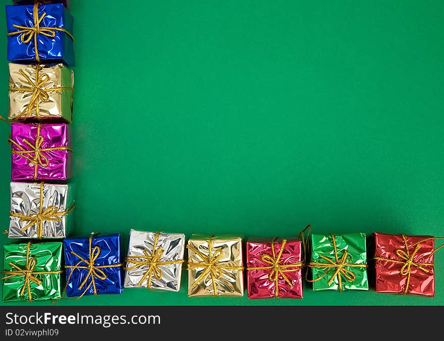 Border of holiday presents on green background. Border of holiday presents on green background