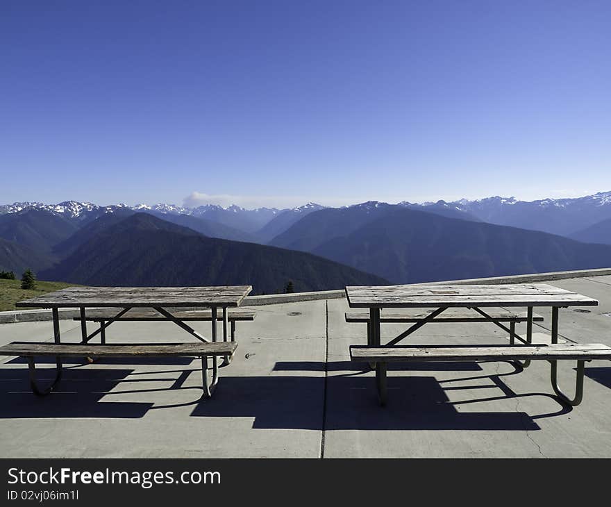 Picnic tables at the mountain summit with view of the range. Picnic tables at the mountain summit with view of the range