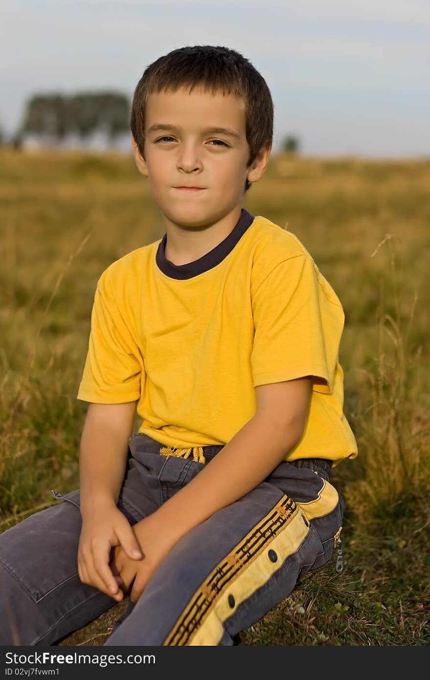 Boy sitting on the grass