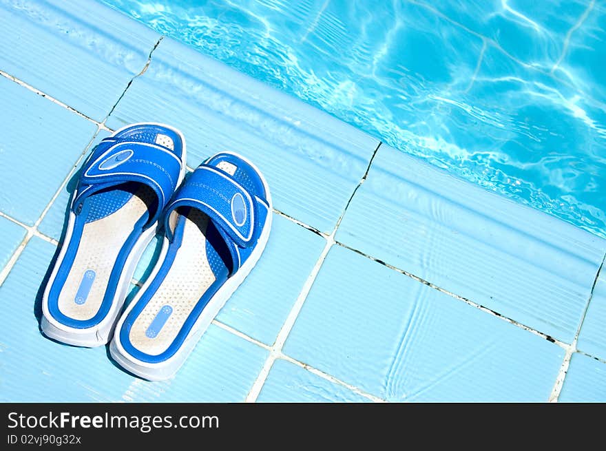 Pretty flip flops by the swimming pool