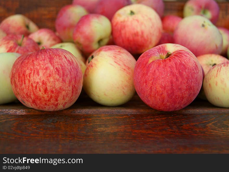 Red apples laying on wooden bench. Red apples laying on wooden bench