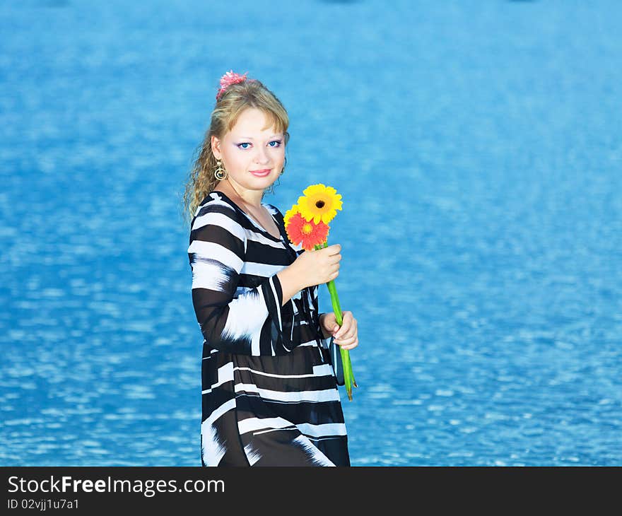 Beautiful woman with flowers in the sea. Beautiful woman with flowers in the sea