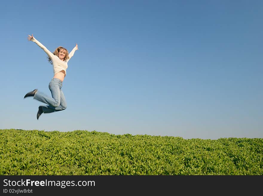 The girl in white jumps in the field. The girl in white jumps in the field