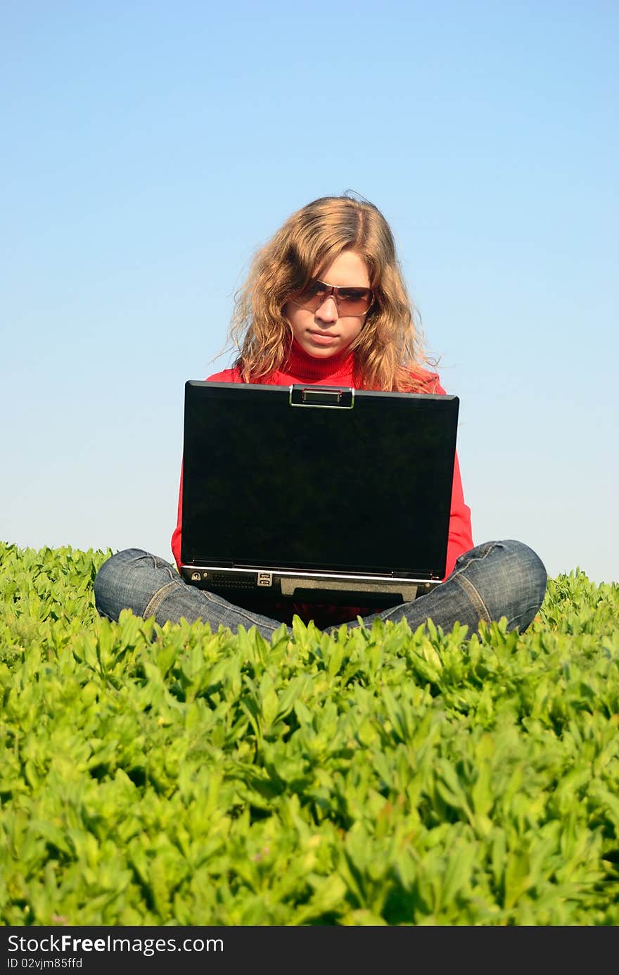 The beautiful girl with the laptop in the field. The beautiful girl with the laptop in the field