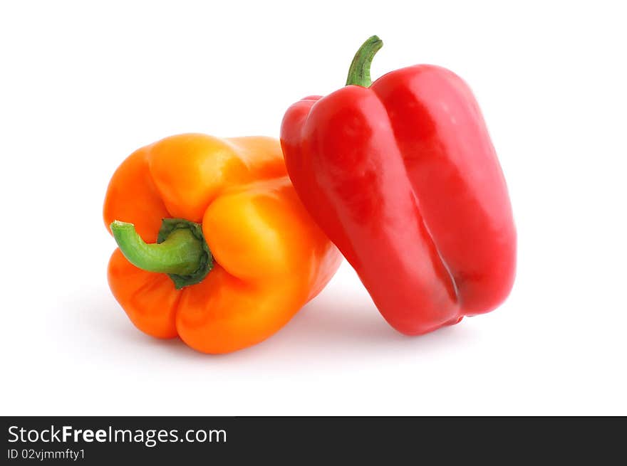 Red and orange bell peppers isolated on white with soft shadow