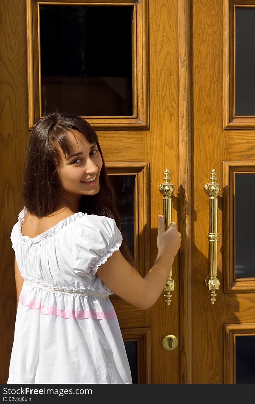 Young attractive girl at the door