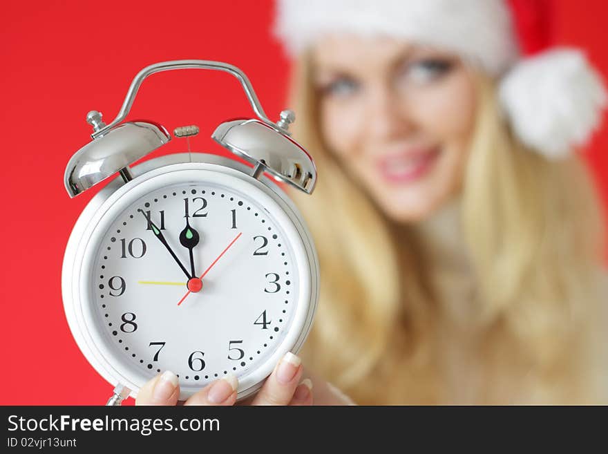 Santa girl holding alarm clock