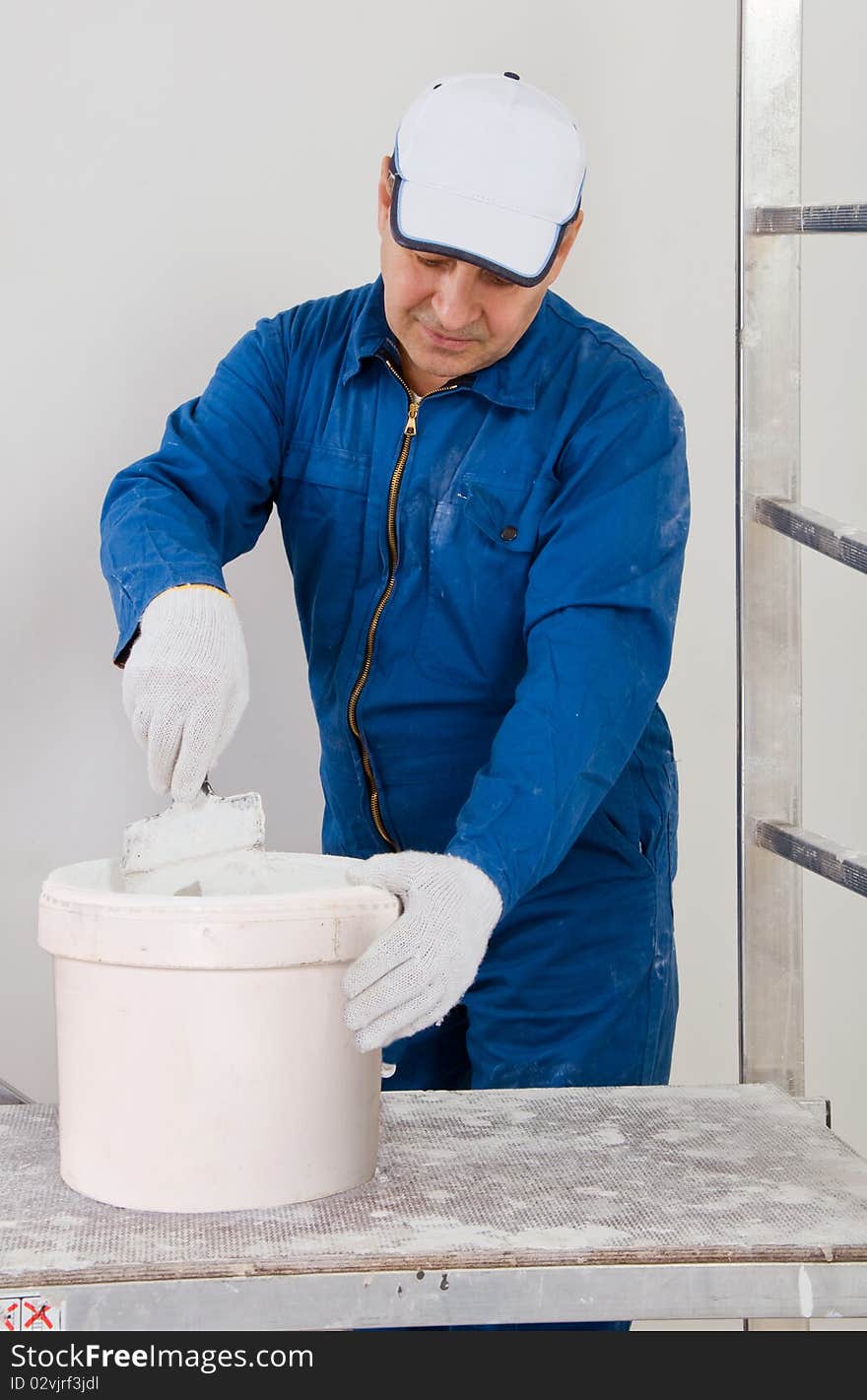 Construction senior  worker mixing paint. Construction senior  worker mixing paint