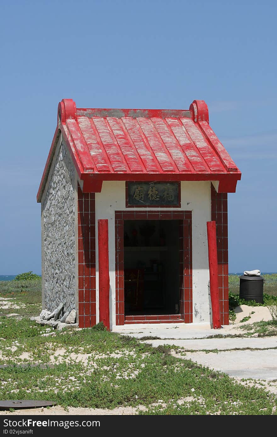 This small red and white house is in fact a Chinese shrine. This small red and white house is in fact a Chinese shrine