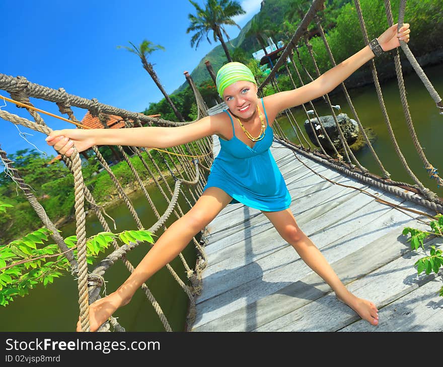 Funny young woman on the suspension bridge. Funny young woman on the suspension bridge