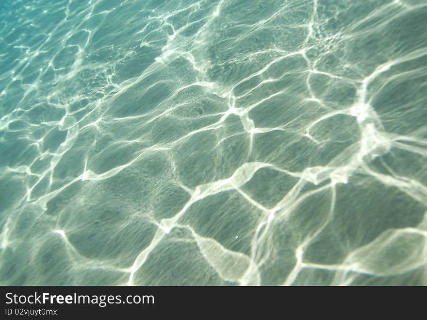 Sunlight reflecting on a the bottom of a shallow underwater bay. Naam Bay, Sharm el Sheikh, Red Sea, Egypt. Sunlight reflecting on a the bottom of a shallow underwater bay. Naam Bay, Sharm el Sheikh, Red Sea, Egypt.