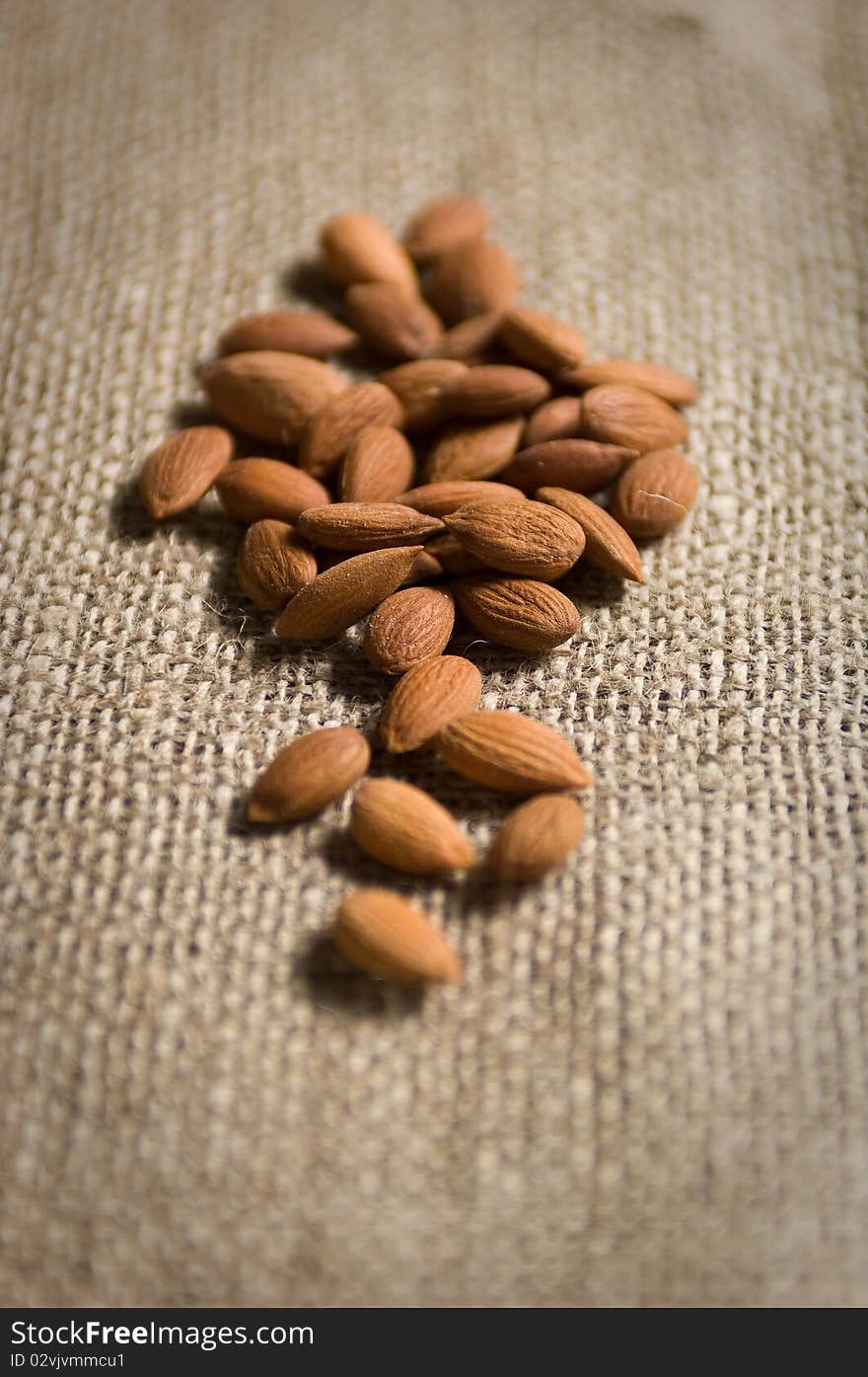 Almonds on top of natural fabrics. Almonds on top of natural fabrics