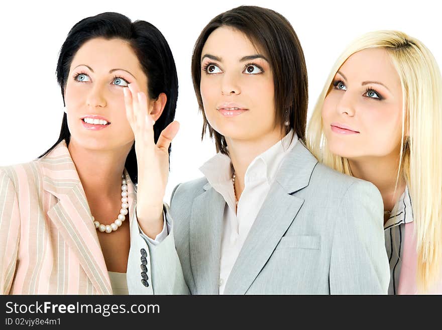 Three beautiful businesswomen looking up, isolated on white. Three beautiful businesswomen looking up, isolated on white